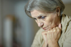 aging woman resting head on fists